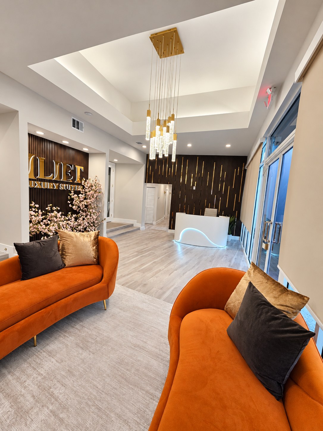 Reception desk and waiting sofas seen from the entry side