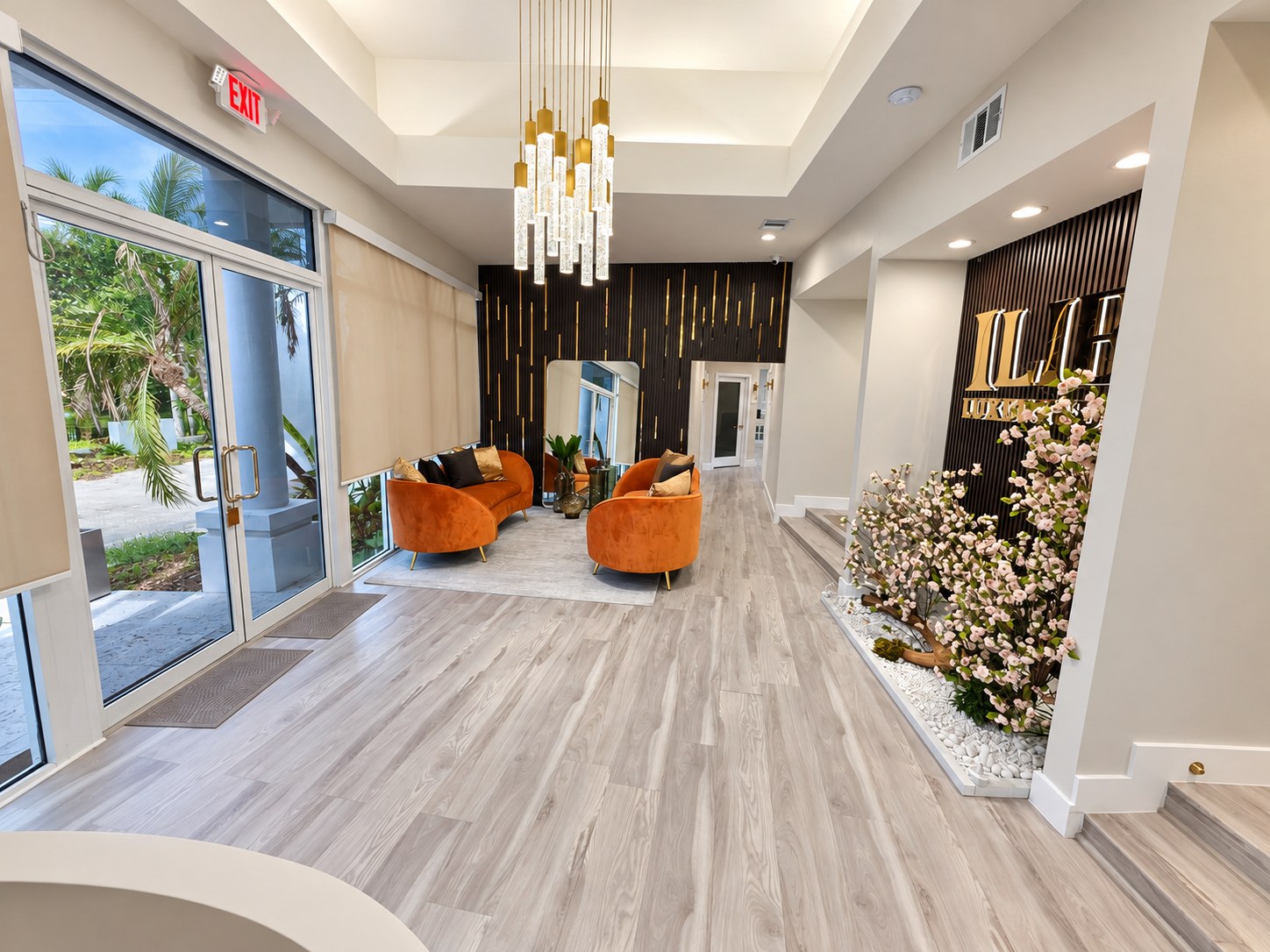 Entry lobby looking toward the glass entrance doors with a floral feature wall
